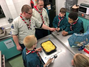 Sparks and Coxswain inspecting the Scouts' cooking efforts