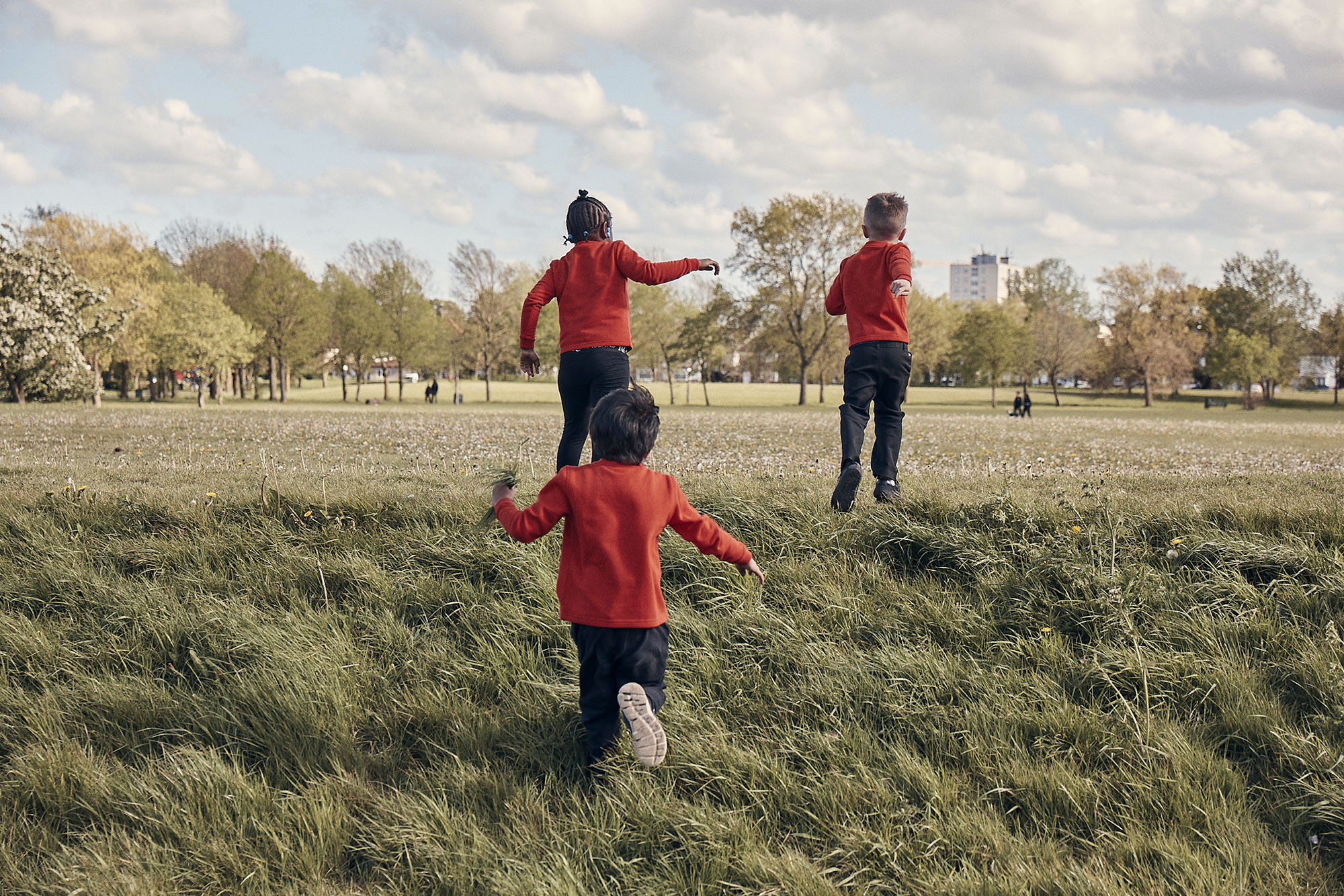 Three Squirrel Scouts run about in the common.